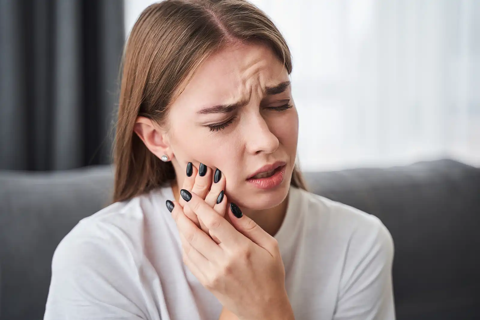 Dental Emergencies Hudson MA Girl with a dental emergency and in pain