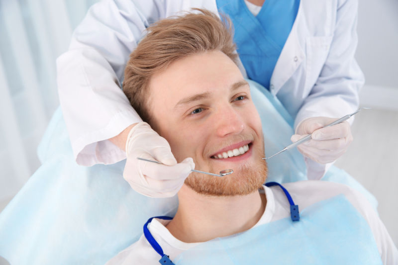 Become a dental patient today at Hudson Family Dental man having teeth cleaned
