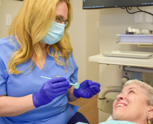 Hygienist and patient at Hudson Family Dental. Family dental care concept.