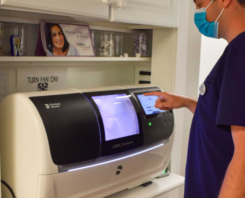 Dentist creating a same day crown with Cerec Restoration at Hudson Family Dental.