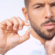 Man holding broken tooth.