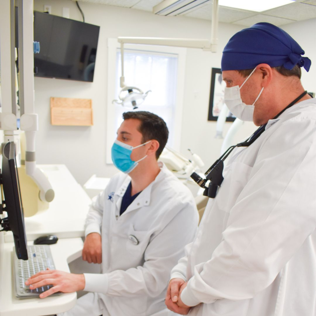Dentists looking at a patient X-ray.